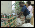 Haven volunteers help unpack canned goods.